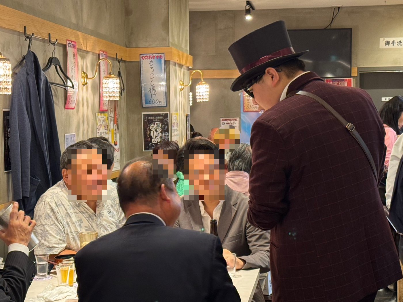 テーブルを囲むお客様に向かってマジックを披露するDaiSuke